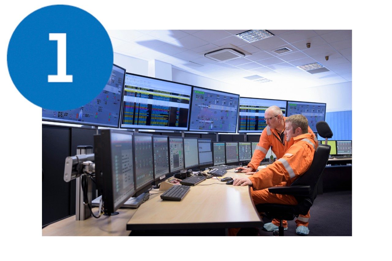 Workers in power station control room 